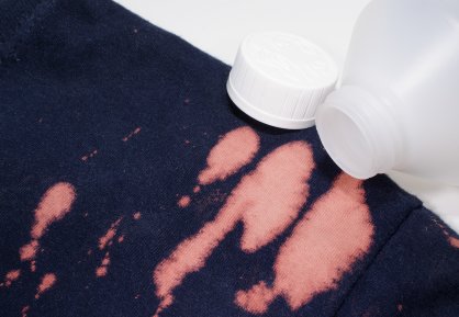 Navy clothing stained with bleach.