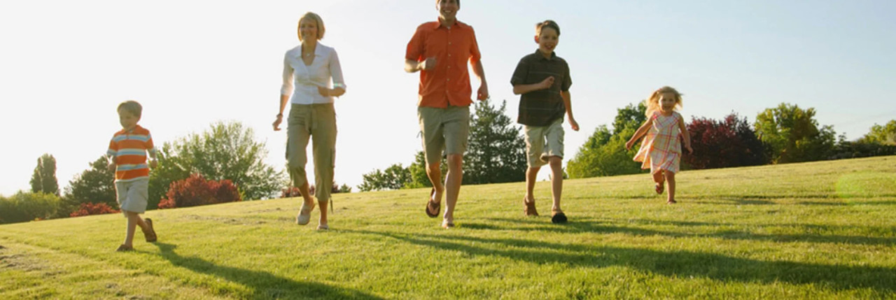 Family running through a field