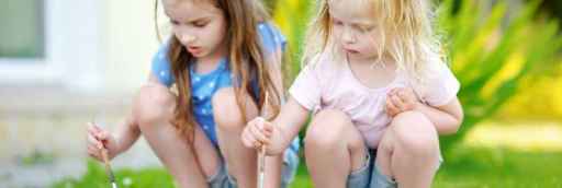 two children outside painting