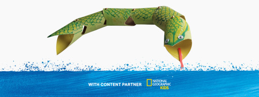 a green craft snake made of used toilet paper tubes