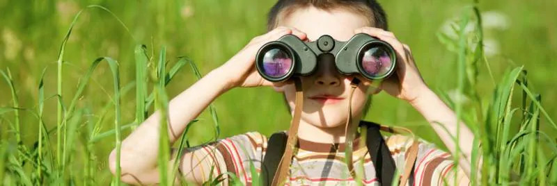 Child looking through binoculars