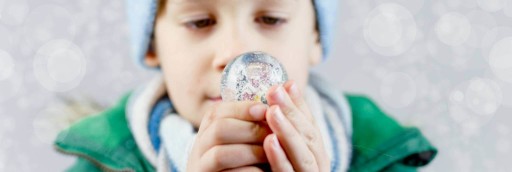 Child holding a snow globe