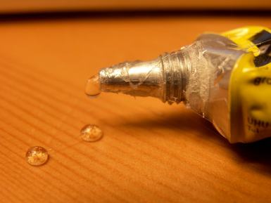 Close up of an adhesive glue stain on a table.