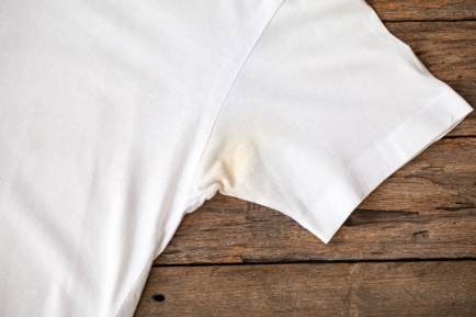 A white t-shirt with a yellowed underarm stain.