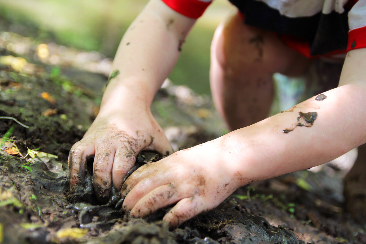 Child with their hands in dirt