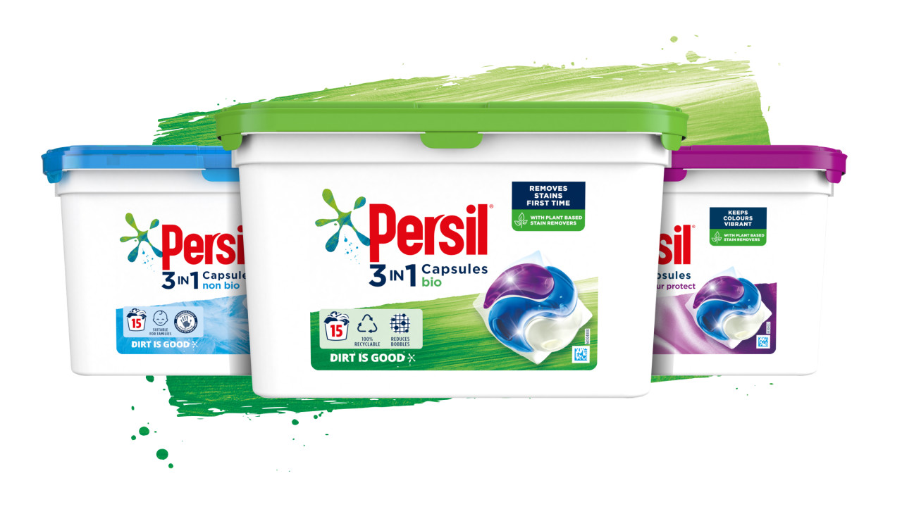 Three Persil capsules boxes against a green paint stroke background
