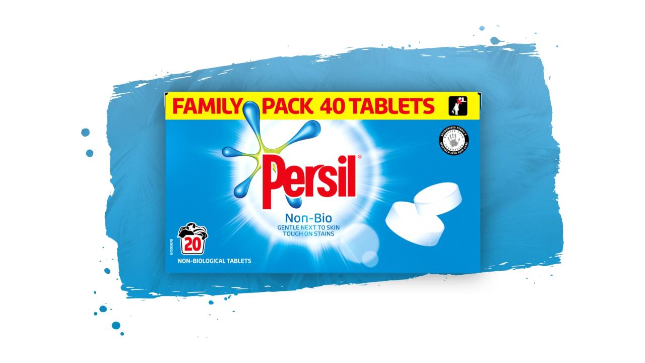 Three Persil tablet products against a green paint stroke background