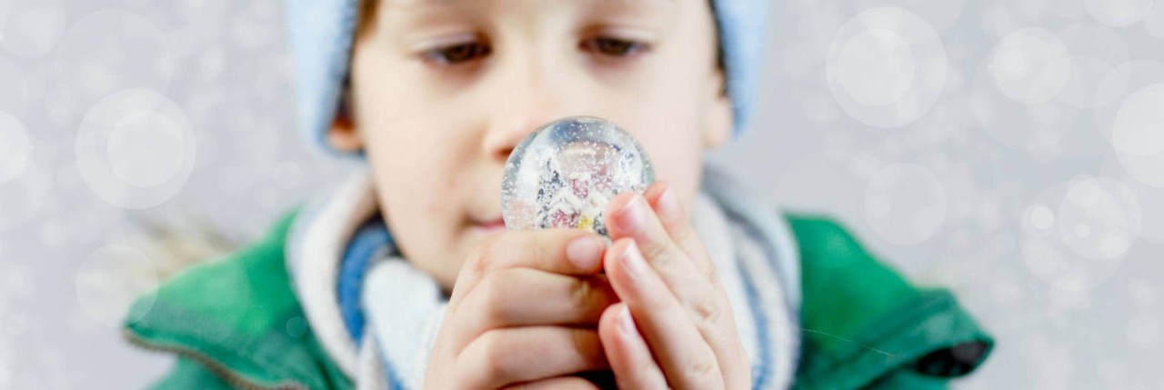 Child holding a snow globe