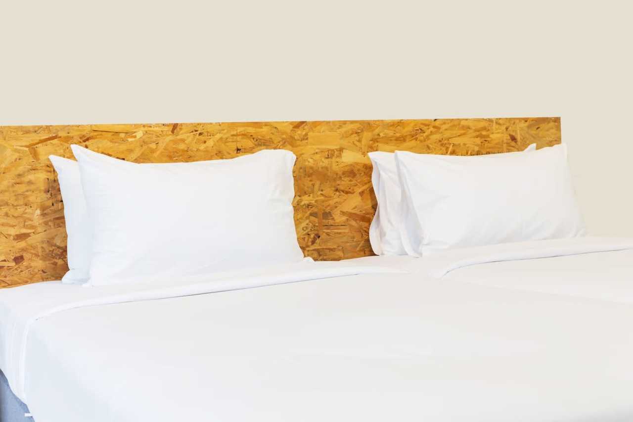 Crisp white sheets and pillowcases on a freshly made bed.